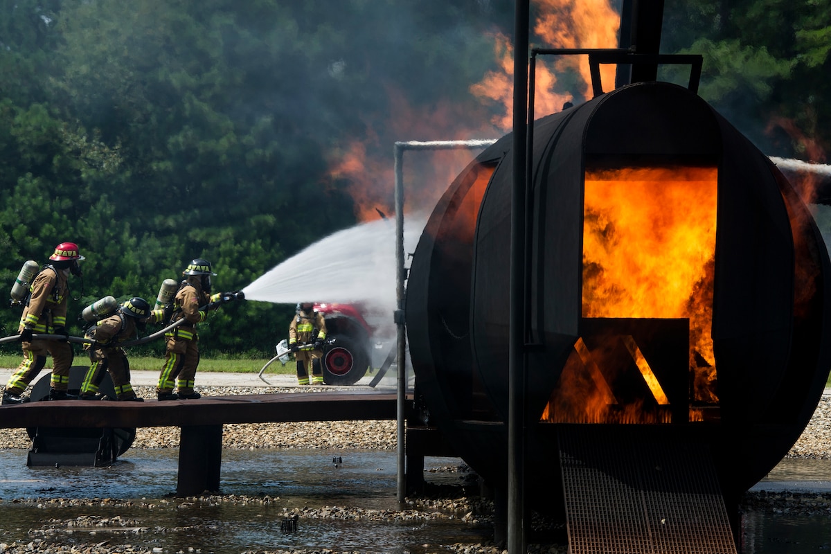A team of Reserve Citizen firefighters respond to a simulated aircraft fire during Patriot Warrior at Dobbins Air Reserve Base, Georgia, Aug. 15, 2018. Reserve Citizen Airmen with the 446th Civil Engineer Squadron from Joint Base Lewis-McChord, Washington, 514th CES, Joint Base McGuire-Dix-Lakehurst, New Jersey and 624th CES, Joint Base Pearl Harbor-Hickam, Hawaii, trained together as one team. The Patriot Warrior exercise supports the Air Force Reserve guiding and foundational principles of preserving, building and shaping a combat ready, cost effective, experienced and sustainable professional military force. (U.S. Air Force photo by Master Sgt. Theanne Herrmann)