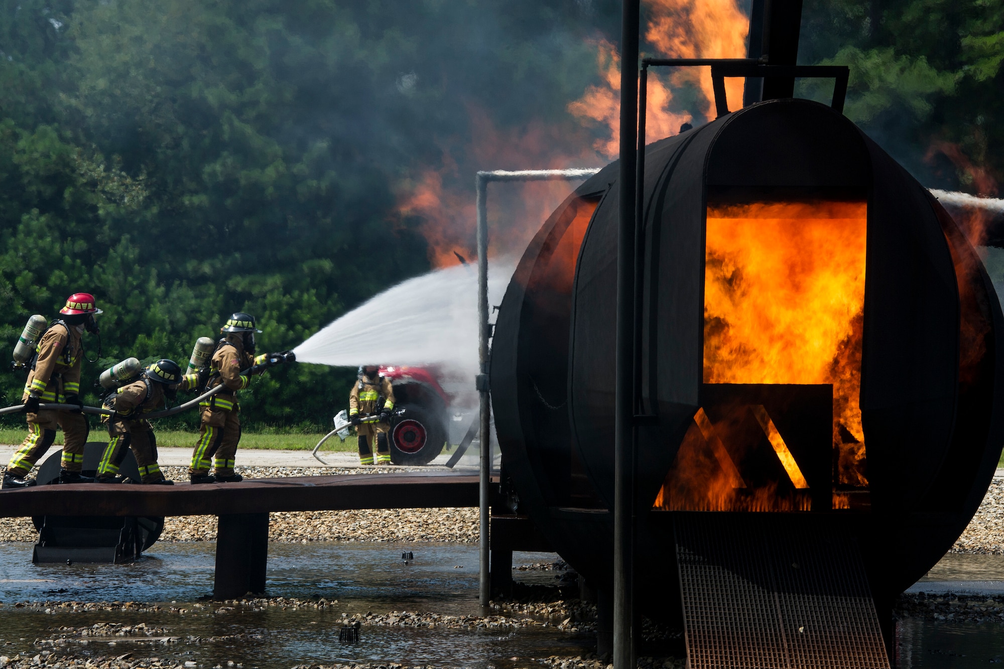 A team of Reserve Citizen firefighters respond to a simulated aircraft fire during Patriot Warrior at Dobbins Air Reserve Base, Georgia, Aug. 15, 2018. Reserve Citizen Airmen with the 446th Civil Engineer Squadron from Joint Base Lewis-McChord, Washington, 514th CES, Joint Base McGuire-Dix-Lakehurst, New Jersey and 624th CES, Joint Base Pearl Harbor-Hickam, Hawaii, trained together as one team. The Patriot Warrior exercise supports the Air Force Reserve guiding and foundational principles of preserving, building and shaping a combat ready, cost effective, experienced and sustainable professional military force. (U.S. Air Force photo by Master Sgt. Theanne Herrmann)