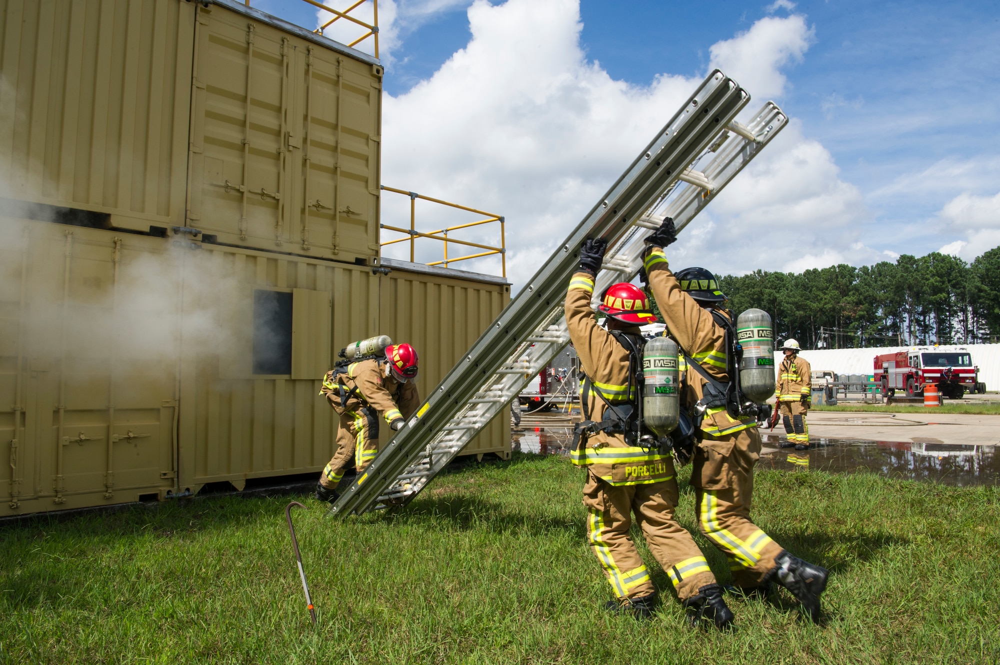 U.S. Air Force Staff Sgt. Jesse Porcelli with the 514th Civil Engineer Squadron from Joint Base McGuire-Dix-Lakehurst, New Jersey and Senior Airman Warren Duke with the 624th CES from Joint Base Pearl Harbor-Hickam, Hawaii, prepare a ladder to retrieve people trapped in a simulated three-story building fire as a part of Patriot Warrior 2018 at Dobbins Air Reserve Base, Georgia, Aug. 17, 2018. Patriot Warrior exercises provide realistic training to build the next generation of leaders to prepare for the fight today and tomorrow. (U.S. Air Force photo by Master Sgt. Theanne Herrmann)