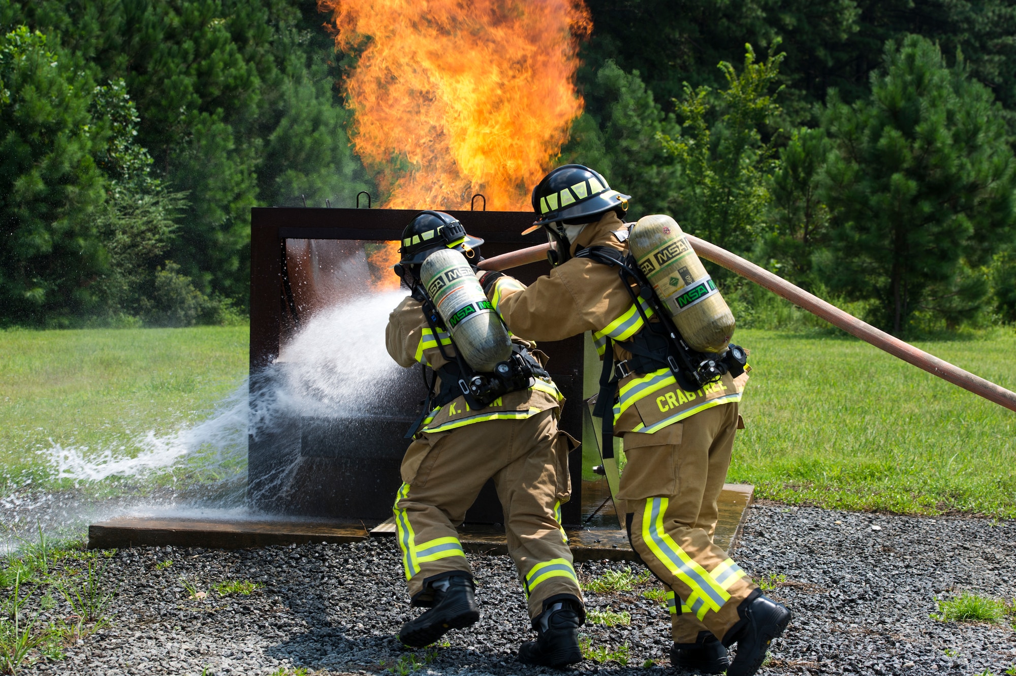U.S. Air Force Senior Airman Kula Funn with the 624th Civil Engineer Squadron from Joint Base Pearl Harbor-Hickam, Hawaii and Staff Sgt. Andrew Crabtree with the 514th CES from Joint Base McGuire-Dix-Lakehurst, New Jersey, respond to a simulated dumpster fire as a part of Patriot Warrior 2018 at Dobbins Air Reserve Base, Georgia, Aug. 13, 2018. Patriot Warrior is an Air Force Reserve exercise designed to prepare Reserve Citizen Airmen for world-wide deployments and provides knowledge and experience to strengthen home station training programs. (Air Force photo by Master Sgt. Theanne Herrmann)