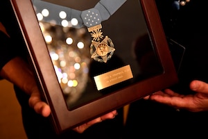 Valerie Nessel, the spouse of U.S. Air Force Tech. Sgt. John Chapman, holds up the Medal of Honor after receiving it from President Donald J. Trump during a ceremony at the White House in Washington, D.C., Aug. 22, 2018. Chapman was posthumously awarded the Medal of Honor for actions on Takur Ghar mountain in Afghanistan on March 4, 2002. His elite special operations team was ambushed by the enemy and came under heavy fire from multiple directions. Chapman immediately charged an enemy bunker through thigh-deep snow and killed all enemy occupants. Courageously moving from cover to assault a second machine gun bunker, he was injured by enemy fire. Despite severe wounds, he fought relentlessly, sustaining a violent engagement with multiple enemy personnel before making the ultimate sacrifice. With his last actions, he saved the lives of his teammates. (U.S. Air Force photo by Staff Sgt. Rusty Frank)