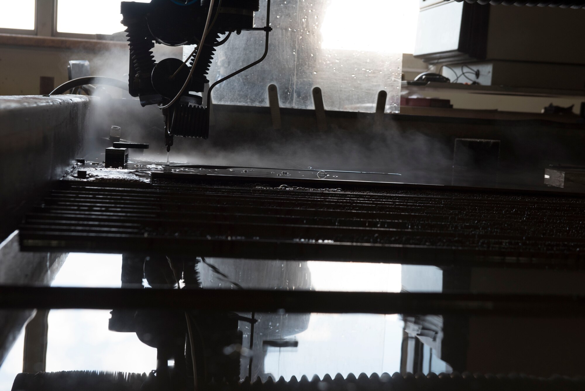 U.S. Air Force Airman 1st Class Thomas Kelley, 18th Equipment Maintenance Squadron metals technology journeyman, operates a water-jet cutting machine Aug. 20, 2018, at Kadena Air Base, Japan. The 18th EMS is working to innovate their shop by training on the use of 3-D printers. When the training is complete, they will be able to create countless parts that are currently ordered, saving Kadena AB man-hours and the Air Force money.