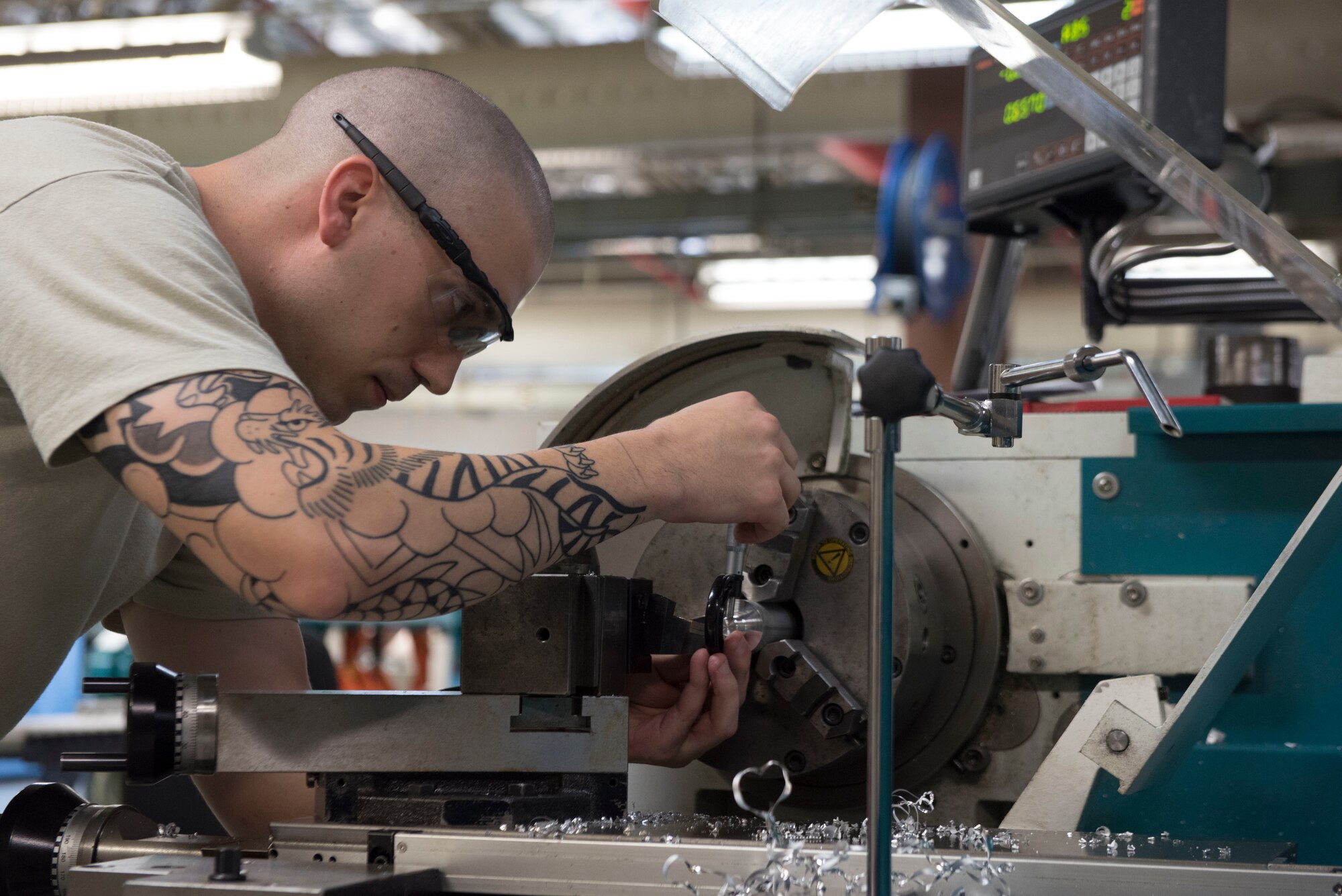 U.S. Air Force Senior Airman Cameron Tugh, 18th Equipment Maintenance Squadron metals technology journeyman, processes metal to create a bushing Aug. 20, 2018, at Kadena Air Base, Japan. Many parts created by the 18th EMS are machined to fit perfectly within their intended locations. Adjustments made can be within the thickness of a single strand of hair to ensure the fit meets mission-ready status.
