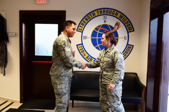 An MXS Airman receives a coin from a Safety officer