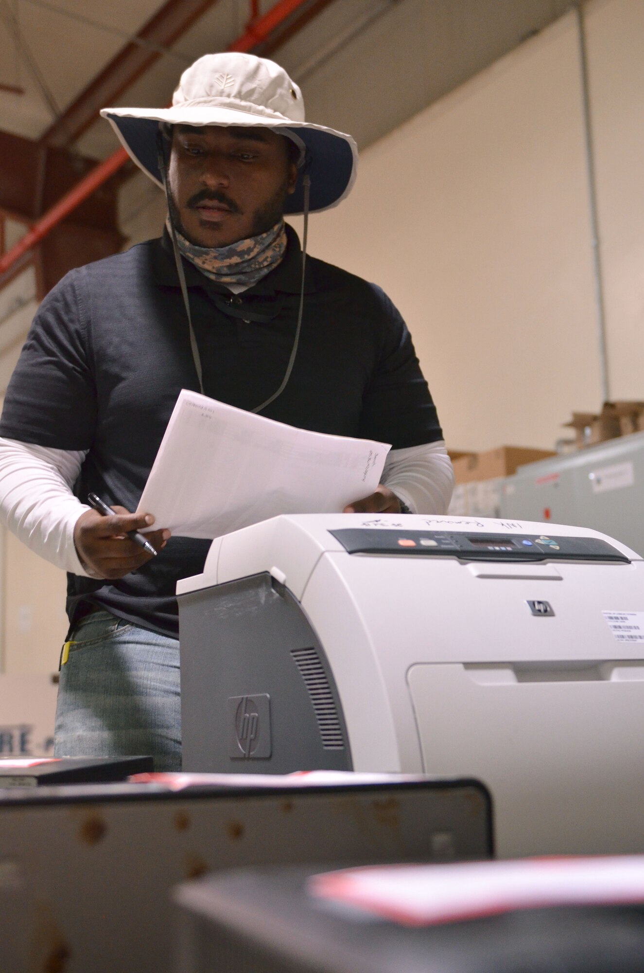 Artemas Tucker, a contracted hardware support technician with the 609th Expeditionary Air Communication Squadron (EACOMS), checks the serial numbers against a list of outgoing equipment, Aug. 8, 2018, at Al Udeid Air Base, Qatar. The EACOMS’ warehouse personnel tracks the $19 million of equipment assigned to the Combined Air Operations Center, supporting a Coalition based mission responsible for planning and executing air operations in support of U.S. Central Command military objectives. (U.S. Air Force photo by Staff Sgt. Caitlin Conner)