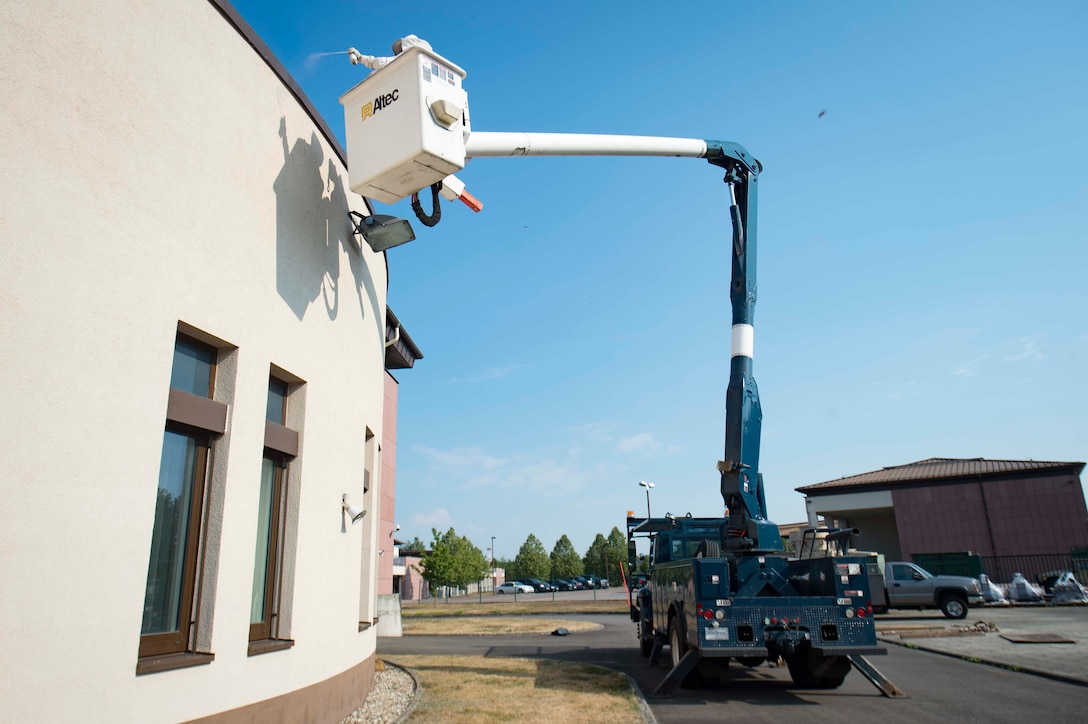 Arturo Basile, 786th Civil Engineer Squadron Pest Management specialist, sprays wasps with pesticide on Ramstein Air Base, Germany, Aug. 7, 2018. Wasp infestations are common in the summer time, and Pest Management clears them from buildings and aircraft to ensure Airmen can continue their mission in comfort and safety. (U.S. Air Force photo by Senior Airman Elizabeth Baker)