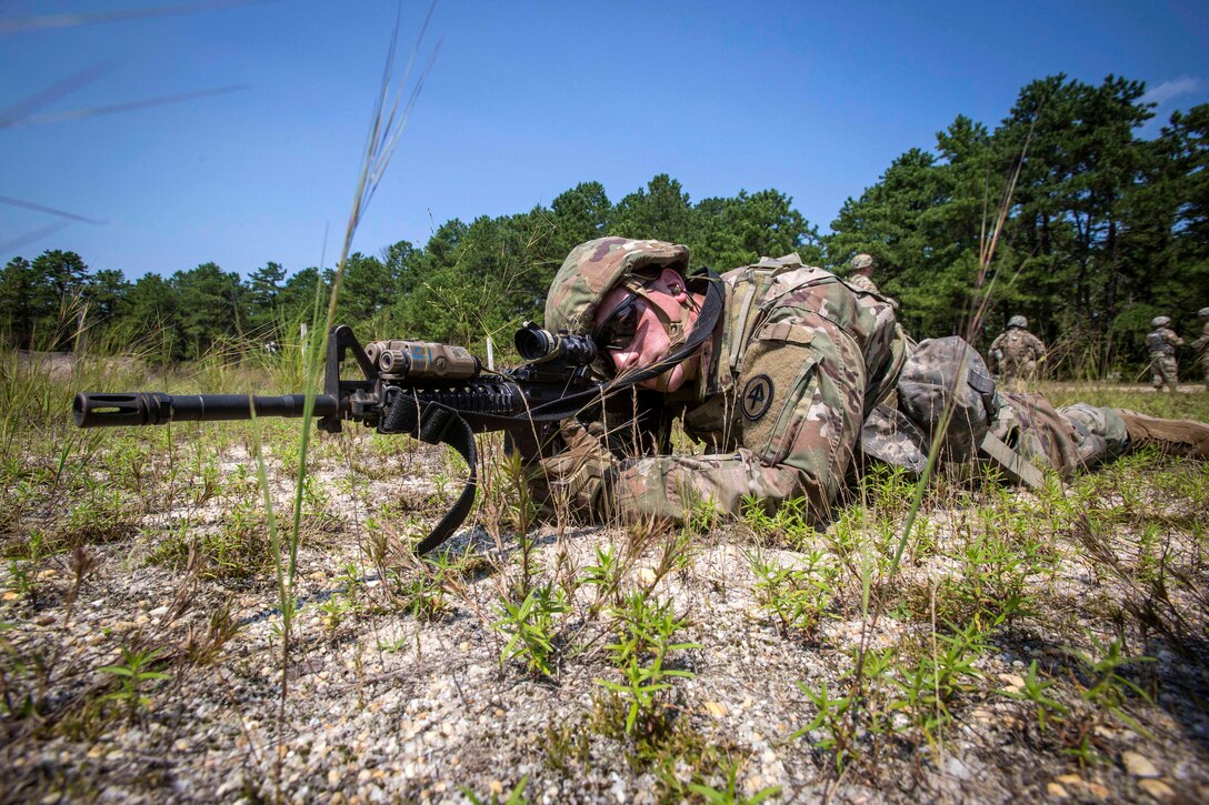 A soldier takes aim while providing security during a live-fire exercise.