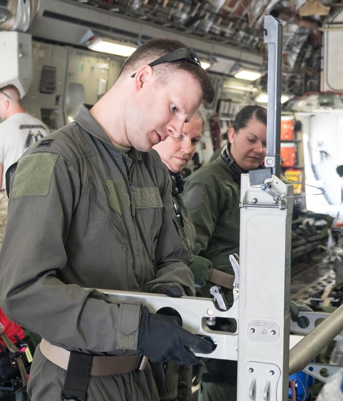 Capt. (Dr.) Joshua Burkhardt, 81st medical Group, Keesler AFB, Miss., sets up litter transport equipment for a CCATT patient.
 (Air Force Photo/Paul Zadach)