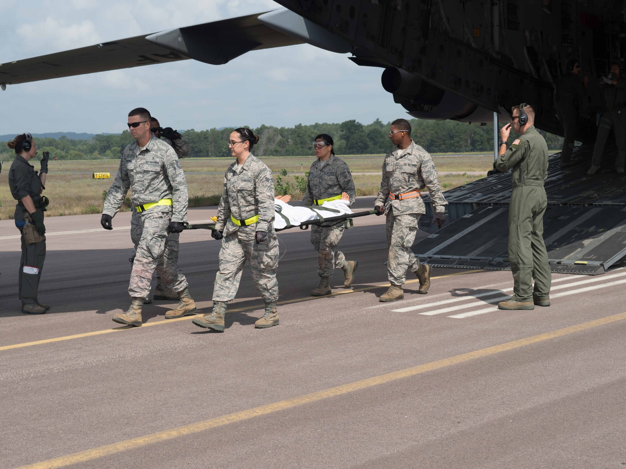 AES "patients" are carried off the C-17 at Fort McCoy to be returned to duty when ready. (Air Force Photo/Paul Zadach)