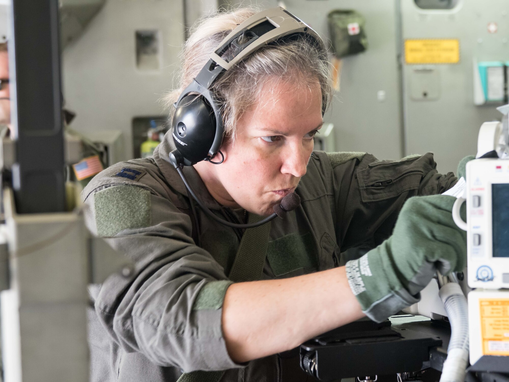 Capt. Tiffany Prochaska, 81st Medical Group, Keesler AFB, Miss., makes some final adjustments to the life support equipment used by the CCATT. (Air Force Photo/Paul Zadach)