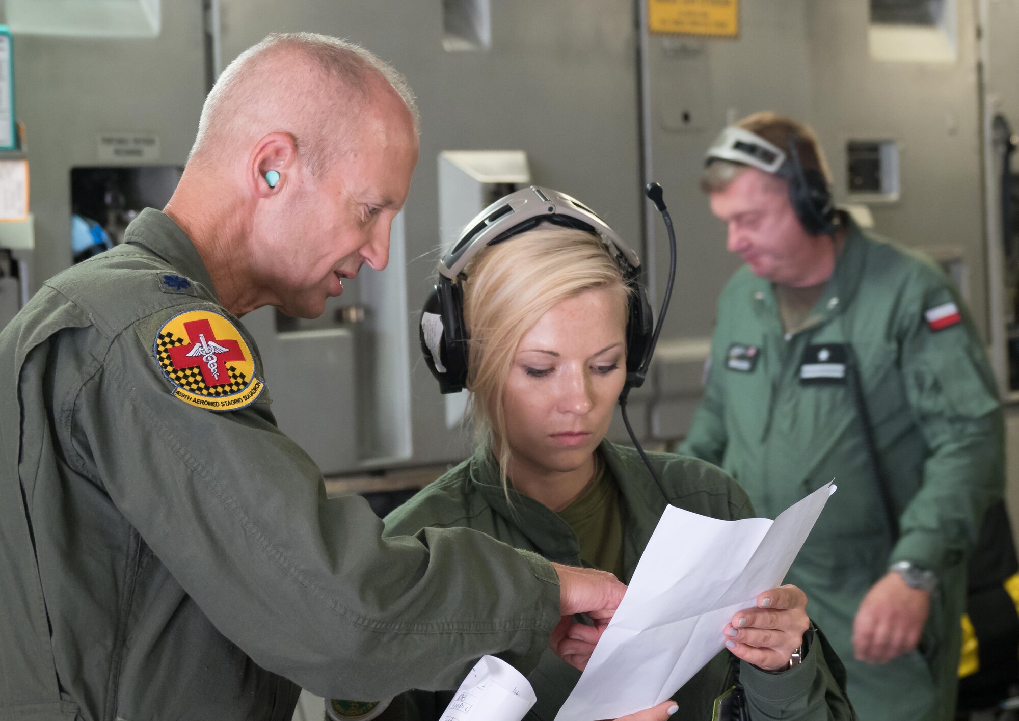 Lt. Col. Patrick Falvey, 459th AES, Joint Base Andrews, Md., reviews procedures with Lt. Marzena Dudaryk of the Polish Air Force. (Air Force Photo/Paul Zadach)