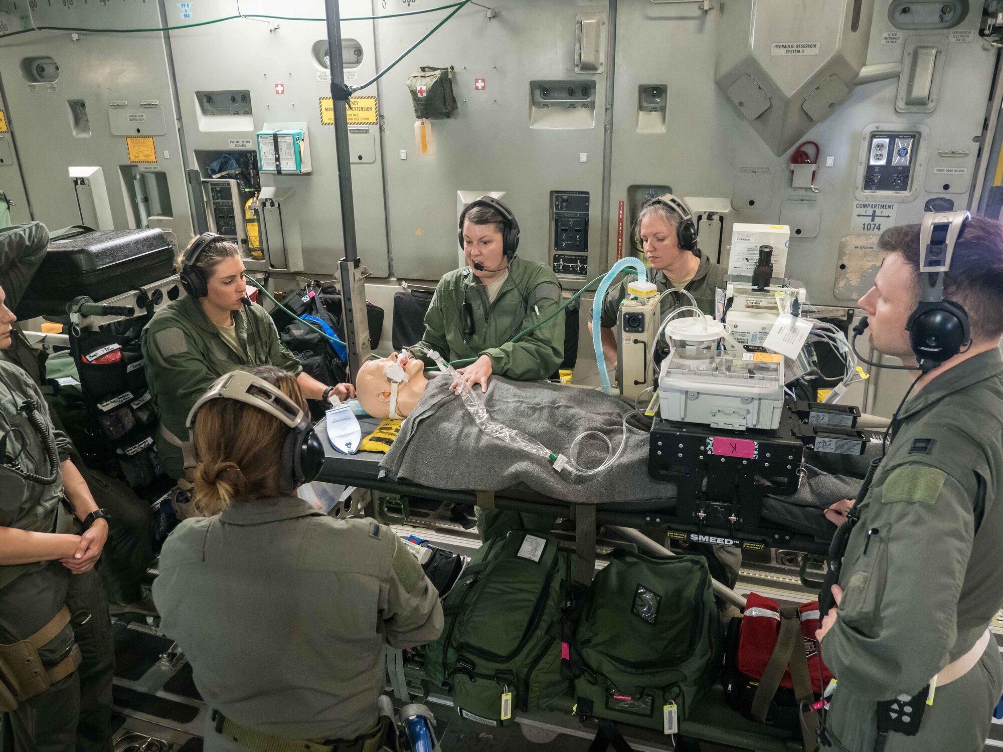 The CCATT assembles for a briefing on the condition of the "patient" during the C-17 flight back to Minneapolis. (Air Force Photo/Paul Zadach)