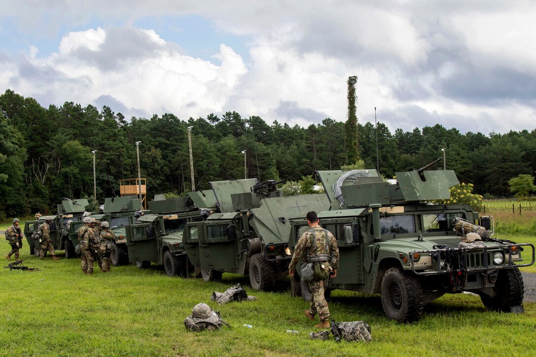 Soldiers prepare their Humvees before conducting a base security exercise.