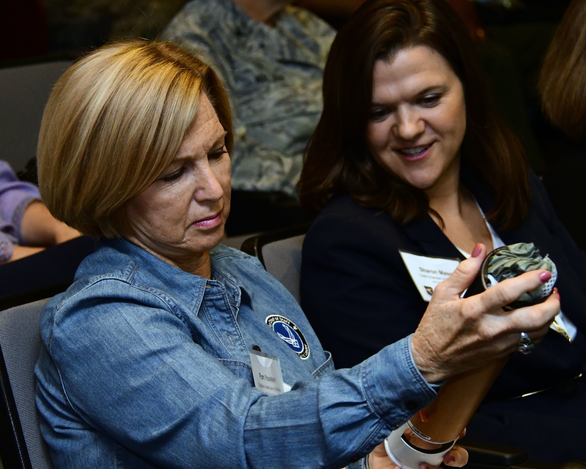 Pam Younker, left, and Sharon Mason, both civic leaders from Georgia, look at a dropsonde during a mission brief on the Air Force Reserve Hurricane Hunters as part of the 22nd Air Force Senior Leader Summit held in August 2018. Dropsondes are dropped from specially equipped C-130s during weather reconnaissance missions to measure storm conditions. (U.S. Air Force photo/Staff Sgt. Andrew Park)
