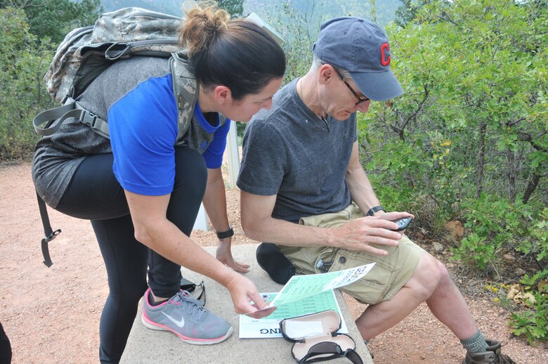 Participants in the 22nd Air Force Senior Leader Summit use GPS coordinates to find a puzzle piece during a geocaching exercise in the Rocky Mountains August 15, 2018. The exercise was held on the final day of the summit and provided participants the opportunity to enhance their teamwork and problem-solving skills. (U.S. Air Force photo/2nd Lt. Casey Mull)