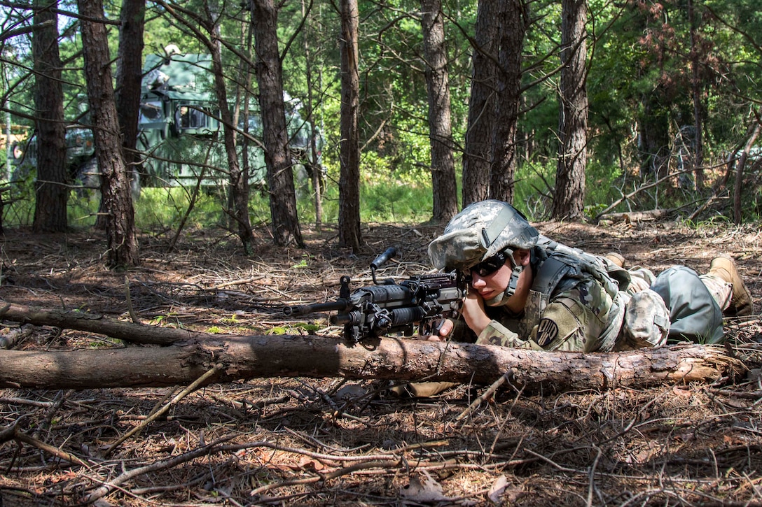 A soldier scans his sector while providing security near a traffic control point.