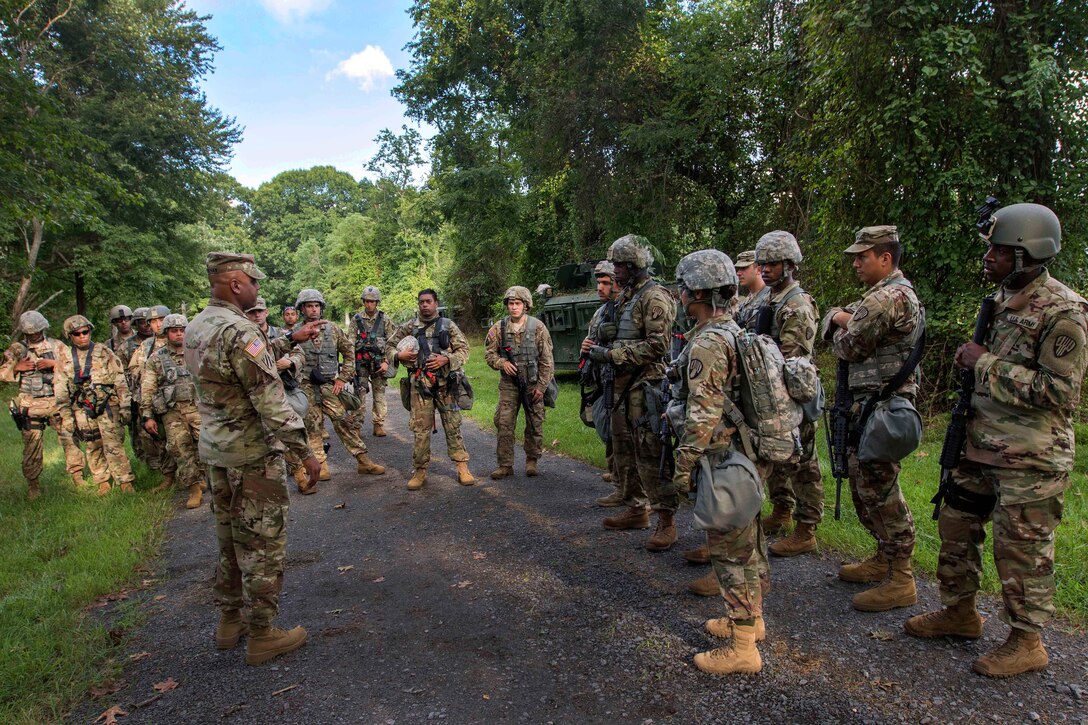 Soldiers review their training following a base security exercise.