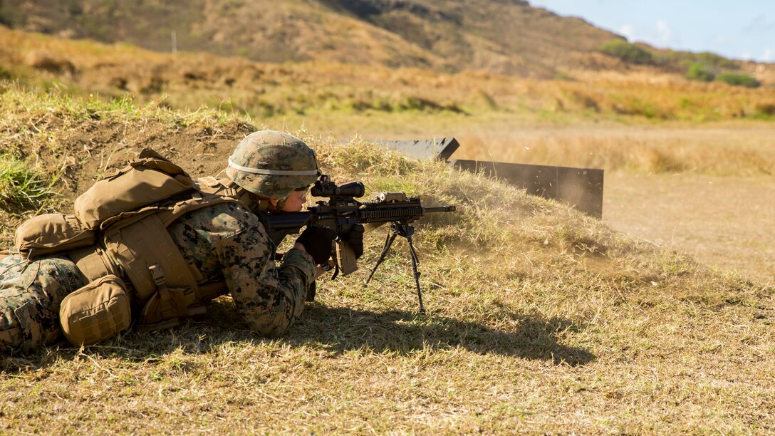 U.S. Marine Lance Cpl. Hugh Atkinson assigned to Kilo Company, 3rd Battalion, 3rd Marine Regiment, fires the M27 Infantry Automatic Rifle at targets on the range during Exercise Bougainville I on Marine Corps Base Hawaii, Kaneohe Bay, Aug. 21, 2018. Bougainville I is the first phase of the pre-deployment training cycle for the battalion and is an exercise focused on building small-unit skills to increase proficiency in combat.