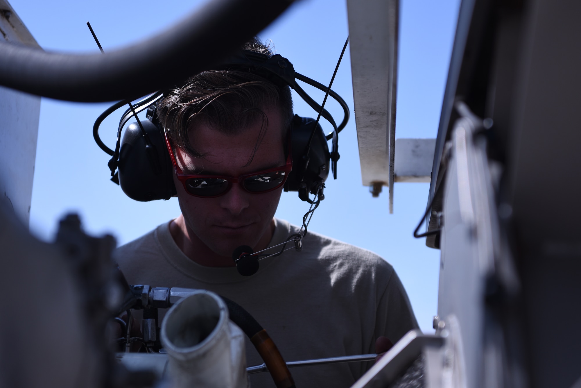 U.S. Air Force Staff Sgt. Michael Prieur, 58th Maintenance Squadron Test Cell maintenance, adjusts a Pratt and Whitney T400 helicopter engine at Kirtland Air Force Base, N.M., Aug. 21, 2018. The T400 powers the UH-1N Huey, a helicopter used to support missile-field operations across Air Force Global Strike Command. (U.S. Air Force photo by Senior Airman Eli Chevalier)