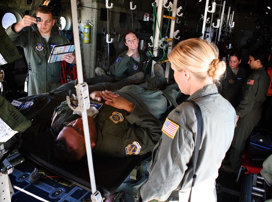 Just before take off, 932nd Aeromedical Evacuation Squadron medical members make final arrangements secure the load, as they work together, preparing to fly with "simulated patients" during a training flight, July 21, 2018 at Scott Air Force Base, Ill. The AES went through multiple checklists as they trained alongside fellow nurses and medical technicians from active duty, on a multi day flight aboard a C-130 aircraft visiting from the 910th Airlift Wing of Youngstown, Ohio. The 932nd Airlift Wing is a 22nd Air Force unit, under the Air Force Reserve Command, and is located at Scott Air Force Base, Ill. (U.S. Air Force photos by Lt. Col. Stan Paregien)