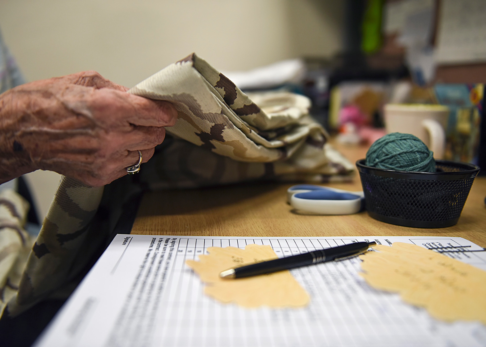 Jane Herron, Davis-Monthan Thrift Shop volunteer worker, sorts and inventories donations at D-M Air Force Base, Ariz., August 22, 2018.