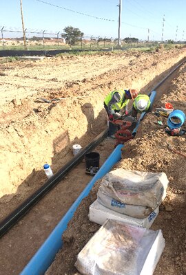 ROTC Cadet Robert Thomas (right) gets a first-hand look at the installation of gas and water utilities for the NNSA Albuquerque Complex Project, Aug. 6, 2018.