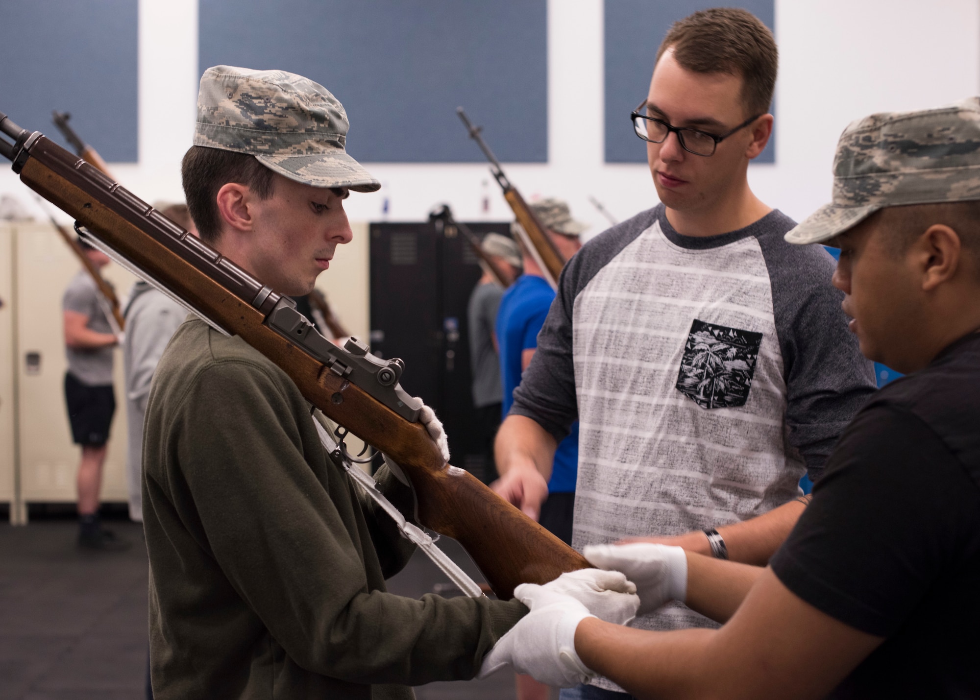 SSgt. Brian Kamphaus, 92nd Air Refueling Wing NCO In-charge of base Honor Guard, helps a trainee adjust his hands during rifle bearing practice at Fairchild Air Force Base, Washington, Aug. 4, 2018. The NCO in-charge position of the Honor Guard flight is a two-year long posting, with the former leader working hands-on to train new leadership. (U.S. Air Force photo/Senior Airman Ryan Lackey)