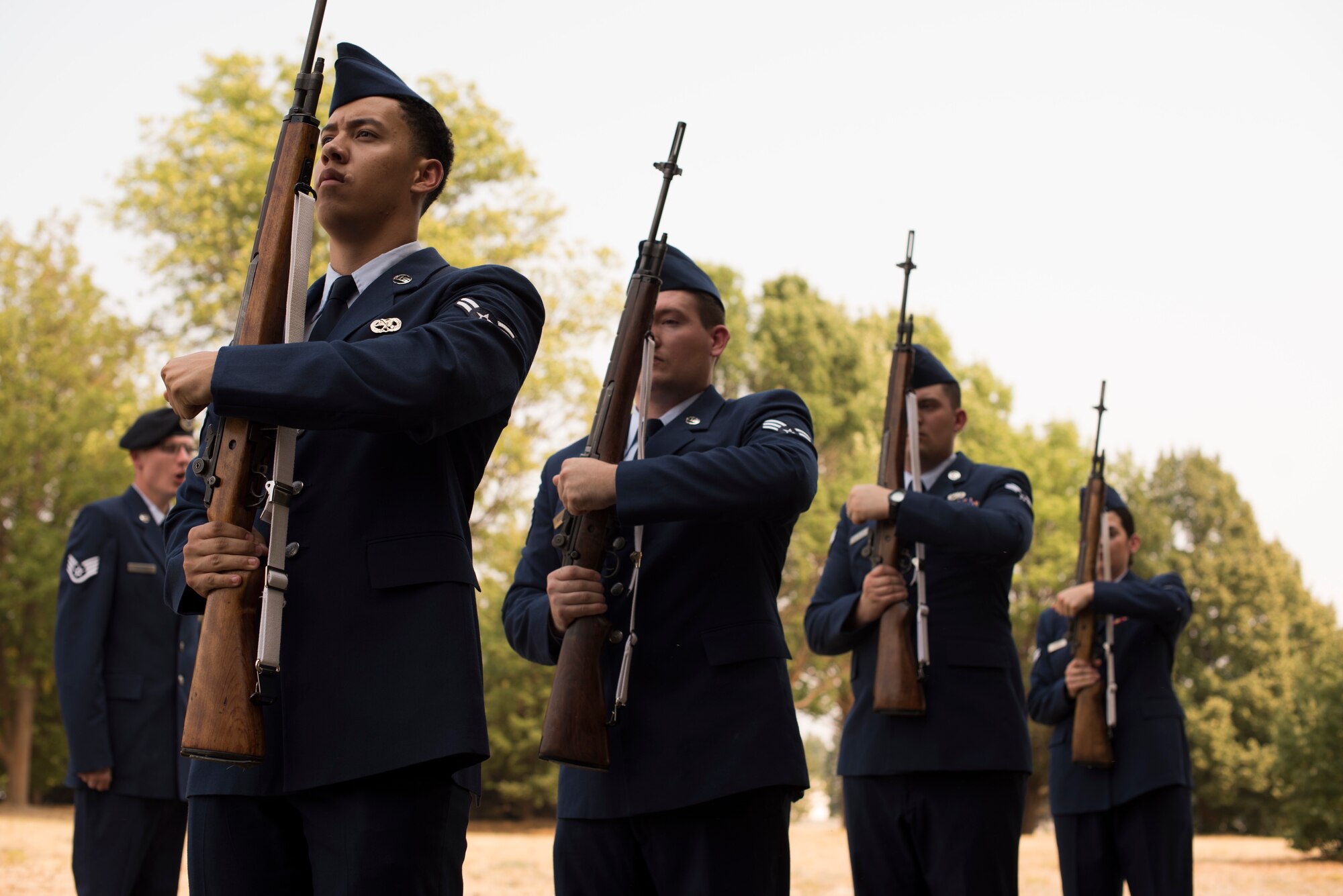 A Base Honor Guard firing party stands ready to fire a volley during a mock funeral ceremony at Fairchild Air Force Base, Washington, Aug. 10, 2018. A “3-rifle volley” is typically a formation of several Honor Guardsmen that fire three reports (shots) in unison to honor a fallen service member during a funeral. (U.S. Air Force photo/Senior Airman Ryan Lackey)