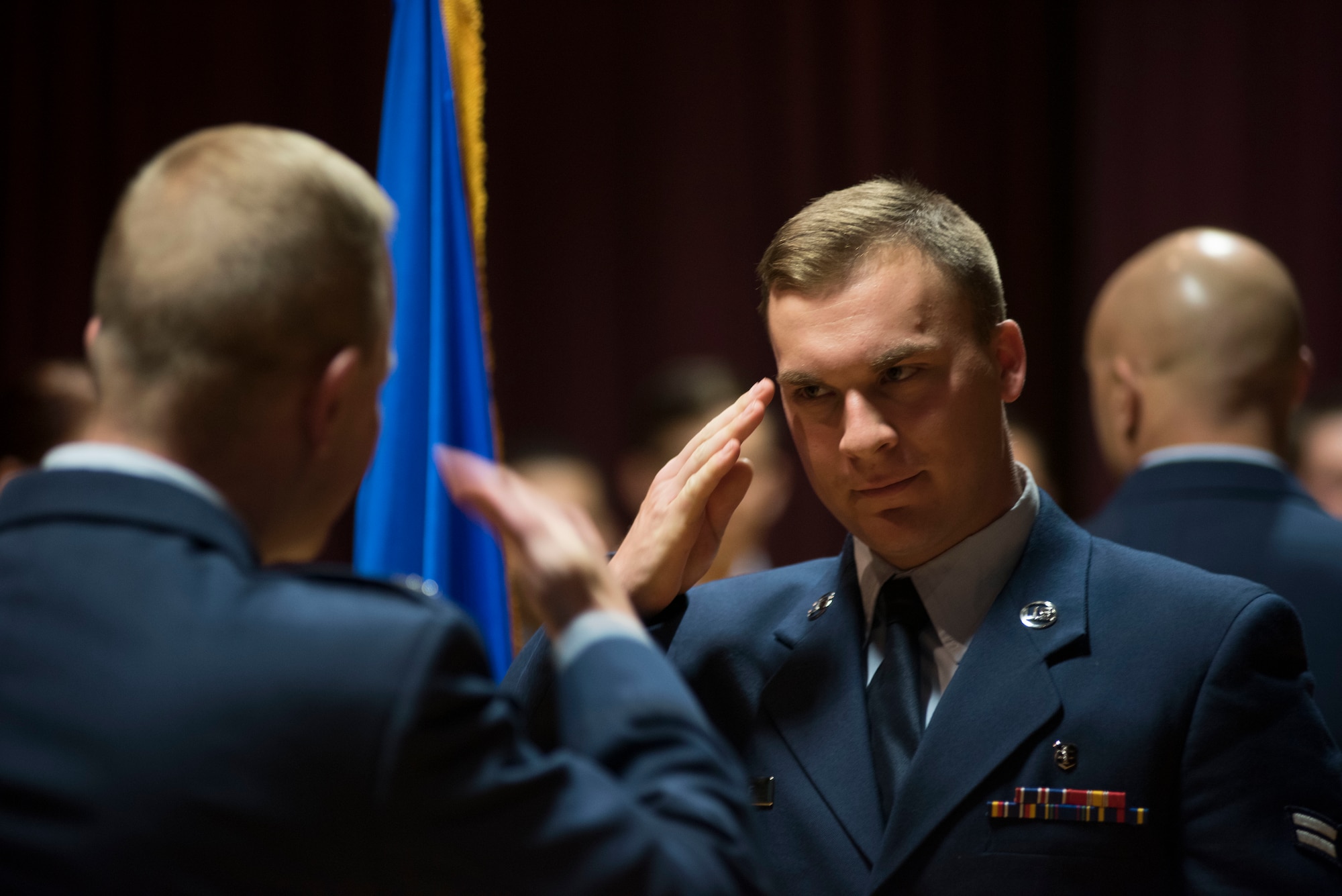 A Base Honor Guard graduate salutes Col. Derek Salmi, 92nd Air Refueling Wing commander, during a graduation ceremony at Fairchild Air Force Base, Washington, Aug. 10, 2018. Graduates will go on to serve for four months, performing dozens of ceremonies on base and across Washington State. (U.S. Air Force photo/Senior Airman Ryan Lackey)