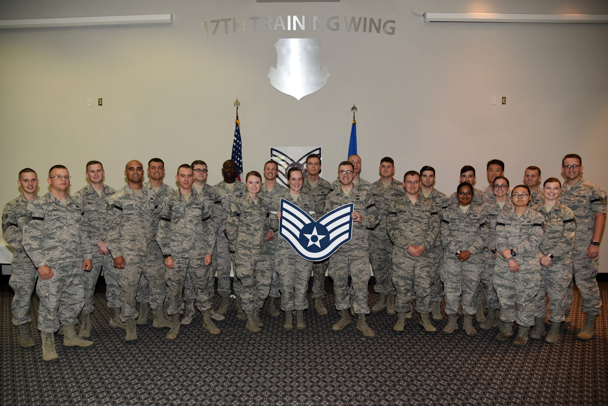 Senior airmen pose for a photo during the Staff Sergeant Release Party at the Event Center on Goodfellow Air Force Base, Texas, Aug. 22, 2018. These senior airmen will make the transition to staff sergeant though the course of the year. (U.S. Air Force photo by Staff Sgt. Joshua Edwards/Released)