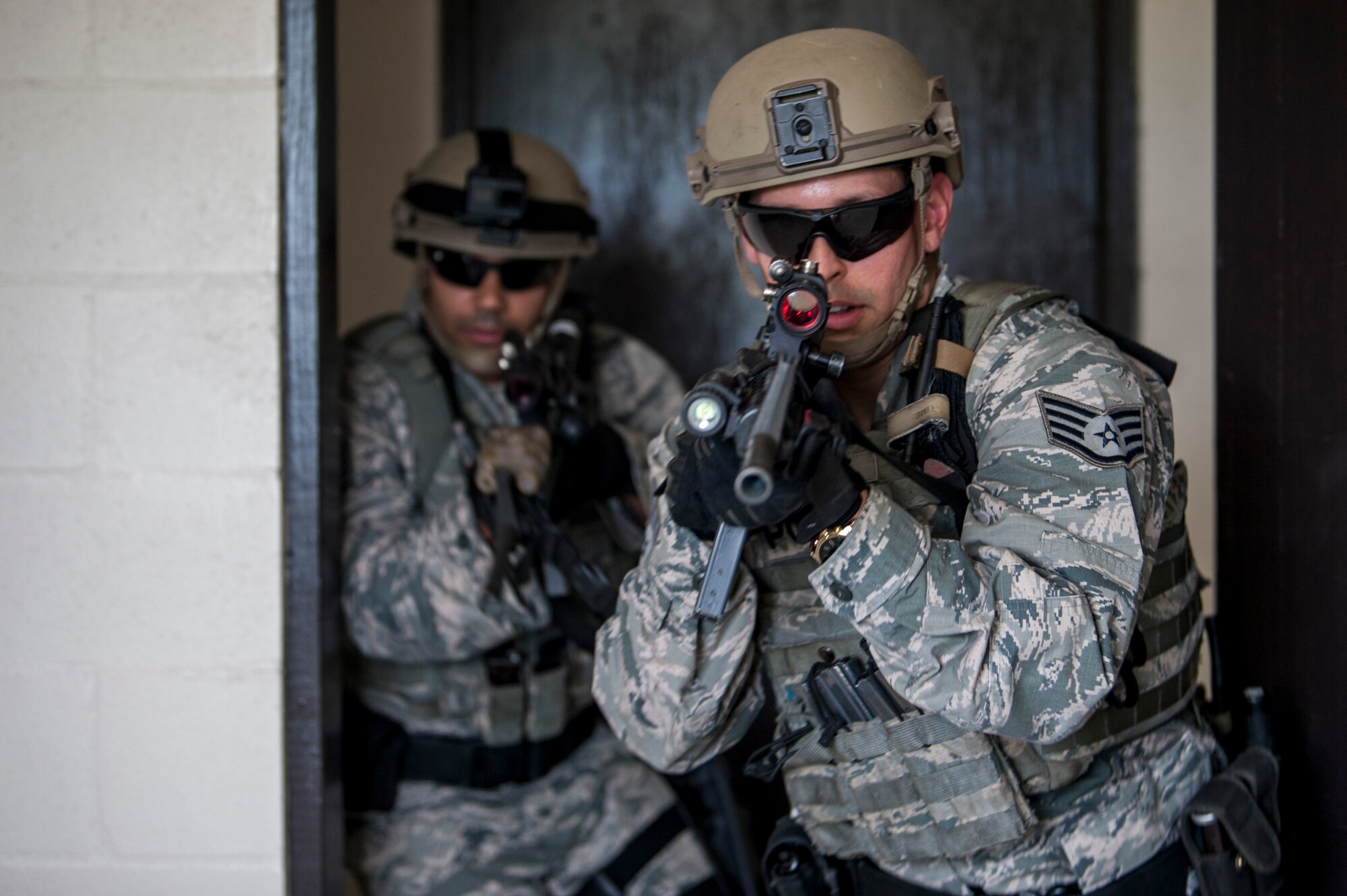 U.S. Air Force Staff Sgt. Kevin Gonzalez, an emergency services team (EST) member and Tech. Sgt. Melvin Santos, an EST leader, both assigned to the 6th Security Forces Squadron (SFS), breach a door in a simulator house at MacDill Air Force Base, Fla., Aug. 22, 2018.