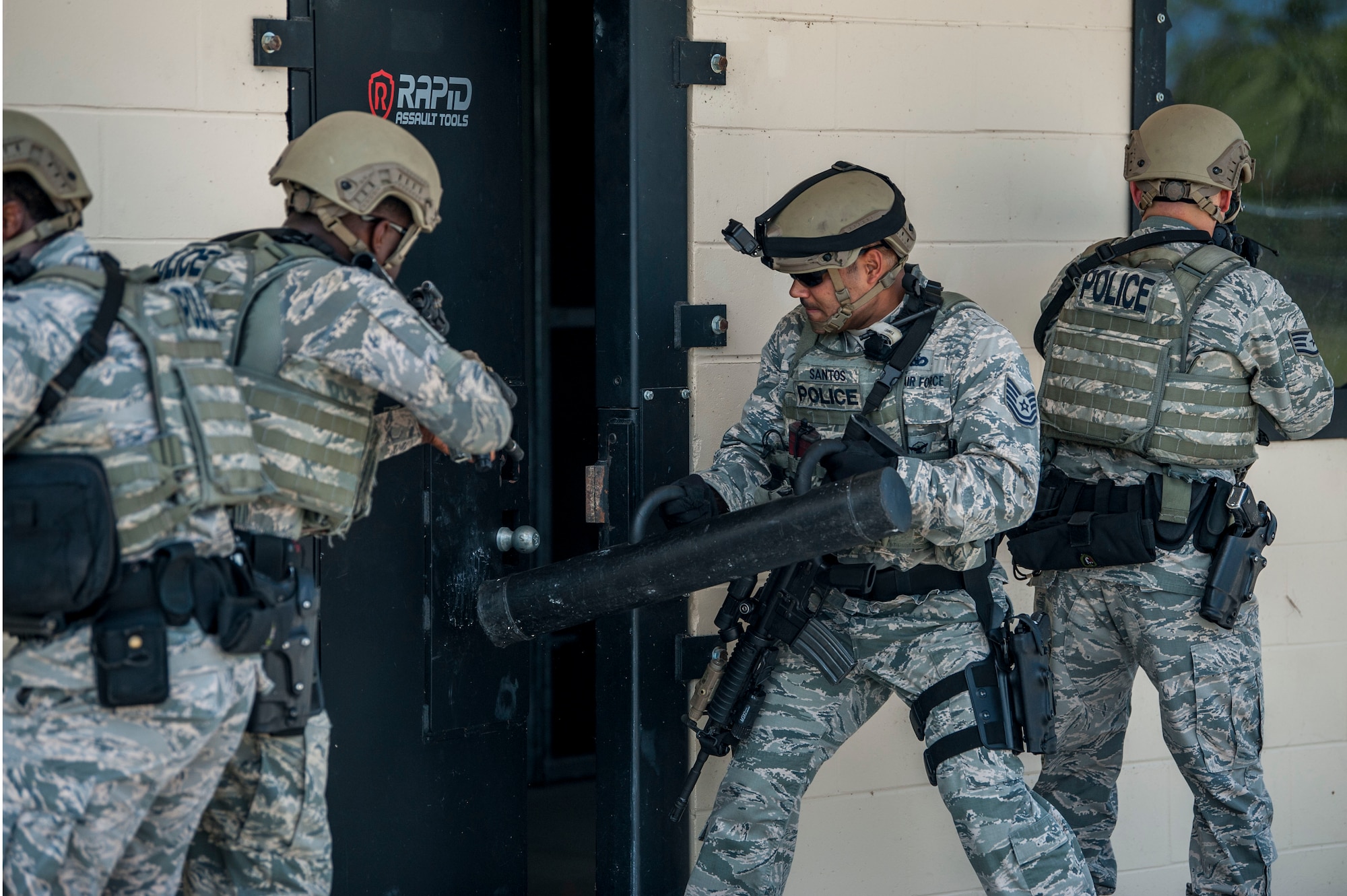 Members of the 6th Security Forces emergency services team (EST) breach an assault door during a training scenario at MacDill Air Force Base, Fla., Aug. 23, 2018.
