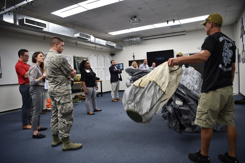 Charleston civic leaders observe a parachute packing demonstration during a two-day tour of MacDill Air Force Base Fla., Aug 16, 2018. The annual civic leader tour allowed community leaders to learn more about the overall Air Force mission and how MacDill AFB 6th Air Mobility Wing's operations work in concert with the Joint Base Charleston mission.