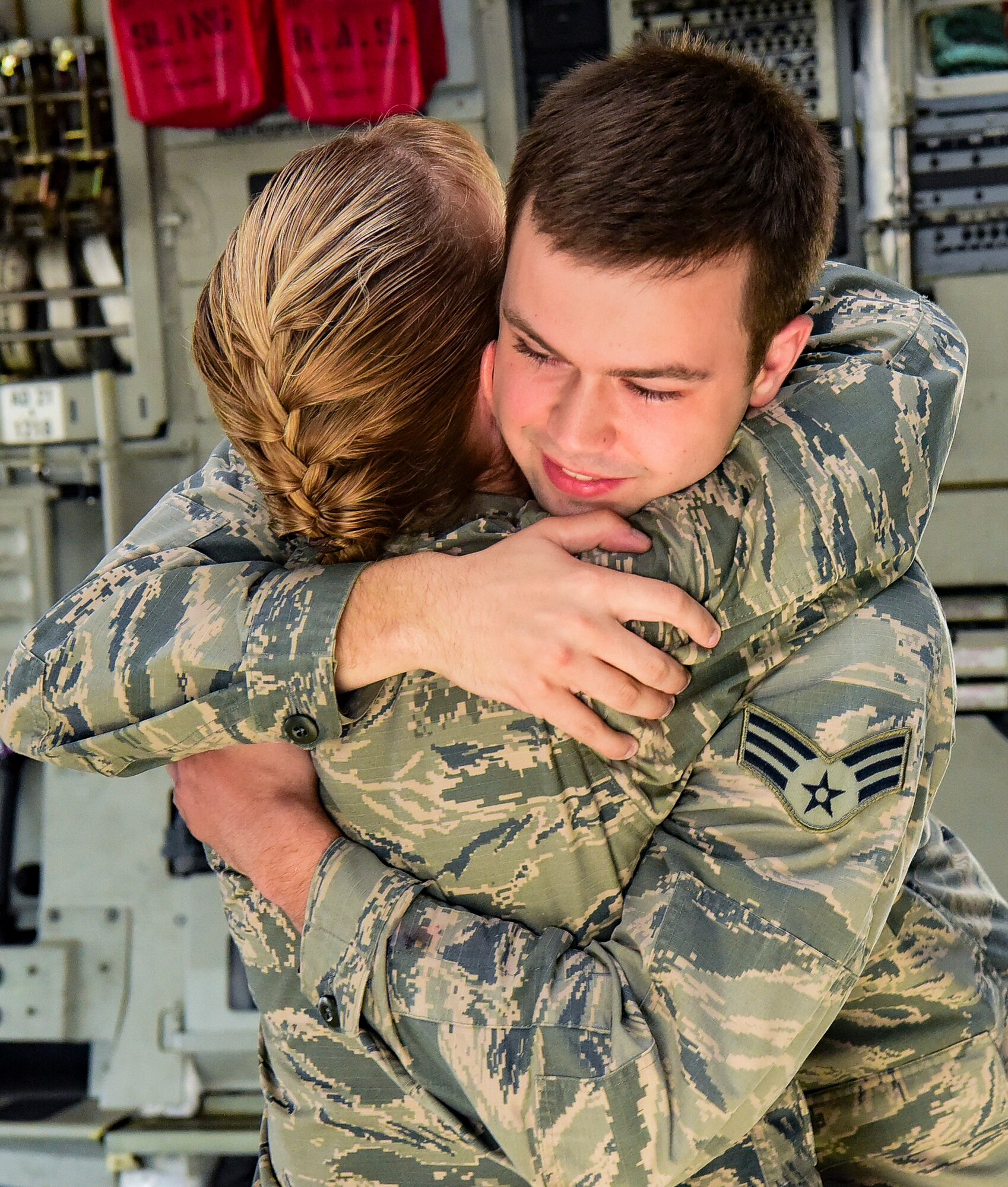 Senior Airman Cody Rupp, 628th Communications Squadron cyber-systems administrator, hugs his mom, Lt. Col. Karen Rupp, 437th Aerial Port Squadron commander, after she performed his re-enlistment ceremony Aug. 21, 2018, at Joint Base Charleston, S.C. The occasion also doubled as a surprise when his mother gave him the good news he had achieved the rank of staff sergeant.