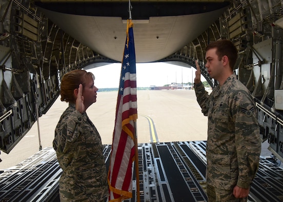 Lt. Col. Karen Rupp, 437th Aerial Port Squadron commander, performs a re-enlistment ceremony for her son, Senior Airman Cody Rupp, 628th Communications Squadron cyber-systems administrator Aug. 21, 2018, at Joint Base Charleston, S.C. The occasion also doubled as a surprise when his mother gave him the good news that he had achieved the rank of staff sergeant.