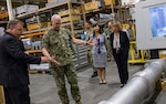 Richard Schumacher, Measurement Science and Engineering Department head, shows a Standard Missile MK-29 vertical launch system canister fit-check tool to Adm. Christopher Grady, U.S. Fleet Forces Commander