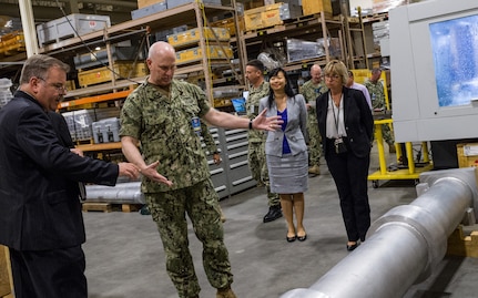 Richard Schumacher, Measurement Science and Engineering Department head, shows a Standard Missile MK-29 vertical launch system canister fit-check tool to Adm. Christopher Grady, U.S. Fleet Forces Commander