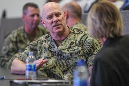 Adm. Christopher Grady, left, U.S. Fleet Forces Commander, discusses technical capability with Dianne Costlow, SES, technical director.