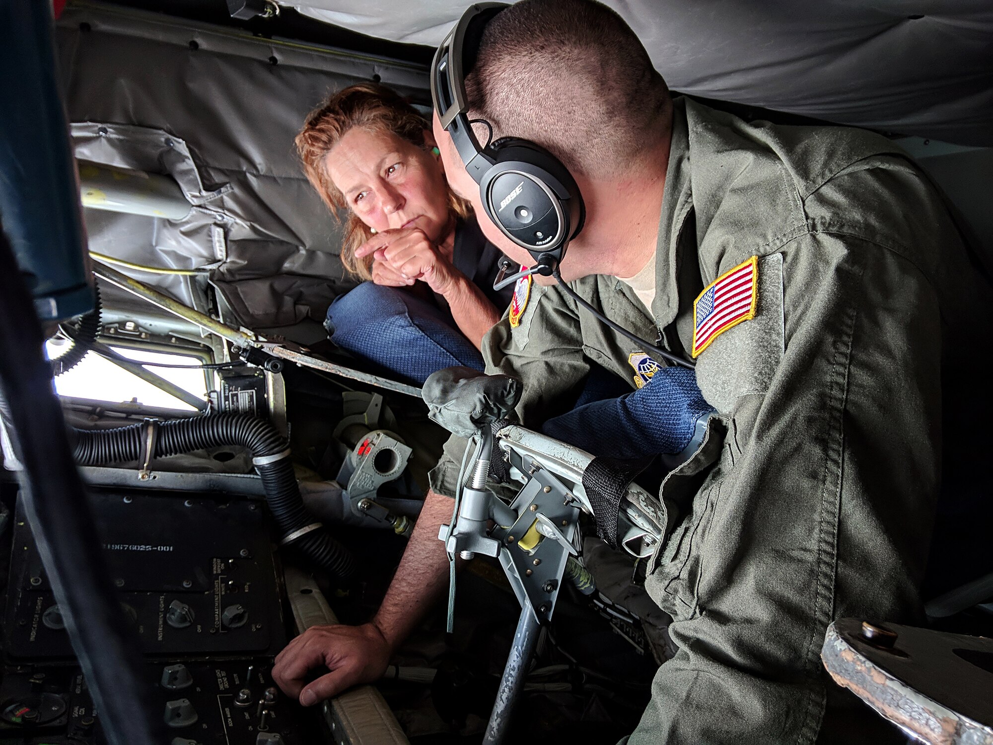 Kate Sharpe, an manager at Concord Hospital, asks questions about the KC-135 Stratotanker to Staff Sgt. Hector M. Acevedo II, a 64th Air Refueling Squadron boom operator, on Aug. 14, 2018. Sharpe traveled to Michigan as part of an Employer Support of the Guard and Reserve tour to Camp Grayling to visit her employee, Maj. Richaqrd LaFlame, a physician's assistant, who also serves as the 197th Field Artillery Brigade surgeon, while he particpated in his unit's annual training event. (Photo by Staff Sgt. Kayla White, 157th Air Refueling Wing Public Affairs)