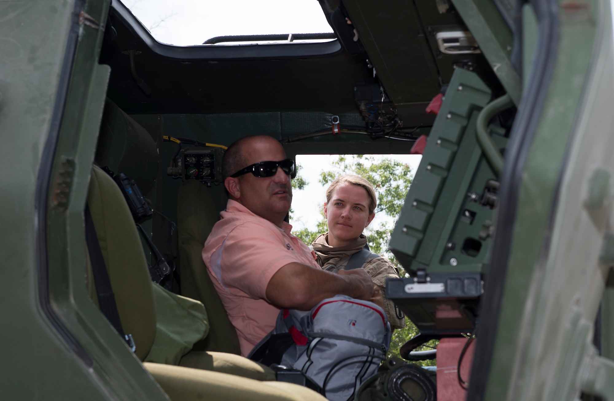 Sgt. Mackenzie C. Sickel, a HIMARS crew chief assigned to the 197th Field Artillery Brigade, N.H. Army National Guard, gives a tour of the weapon system to Jason J. LaVoie, the chief of the Hudson Police Department, on Aug. 14, 2018 at Camp Grayling, Mich. Lavoie visited as part of a N.H. Employer Support of the Guard and Reserve tour during the 197th FAB annual training event. (Photo by Staff Sgt. Kayla White, 157th Air Refueling Wing Public Affairs)