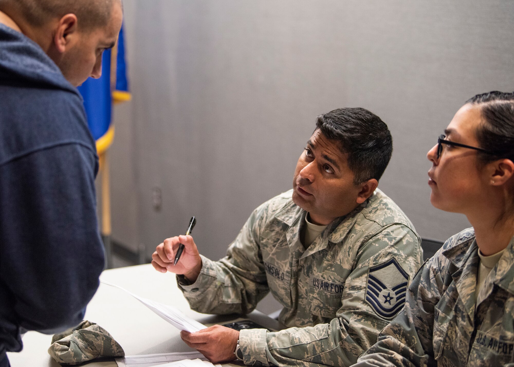 Master Sgt. Demetrios Consolo, 310th Aerospace Medicine Flight, assists an Individual Ready Reserve member with his medical records during an IRR muster at Peterson Air Force Base, Aug. 17, 2018.