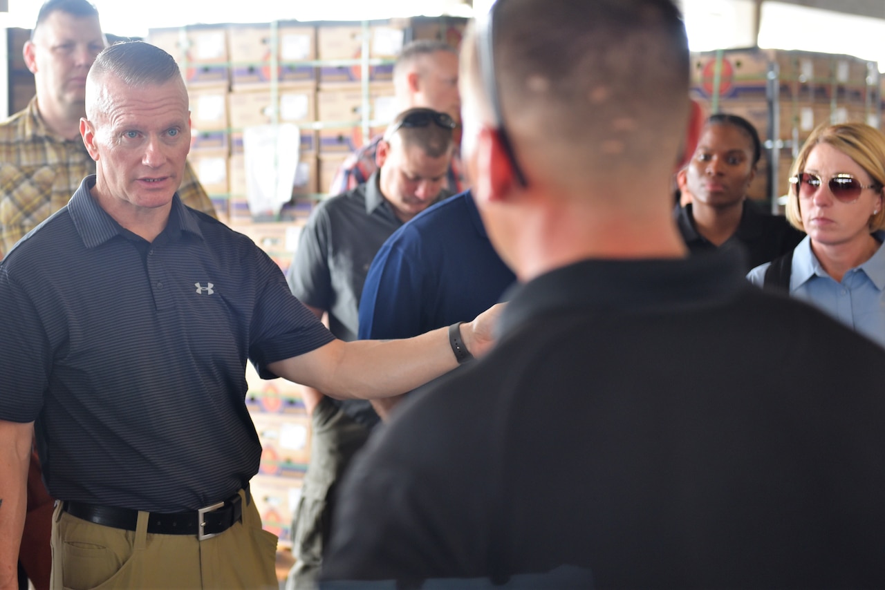Army Command Sgt. Maj. John Wayne Troxell, senior enlisted advisor to the chairman of the Joint Chiefs of Staff, speaks with a Defense Department K-9 handler at the Pharr, Texas, port of entry.
