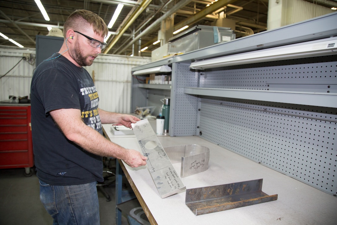 Dale Bailey, mobile equipment metal mechanic, designs and fabricates a template for part of a propulsion shaft cover for an amphibious assault vehicle in the Fabrication Shop at Production Plant Barstow, Marine Depot Maintenance Command, on the Yermo Annex aboard Marine Corps Logistics Base Barstow, Calif., Aug.16. The shop can use the template to produce multiple parts to efficiently repair the AAVs.