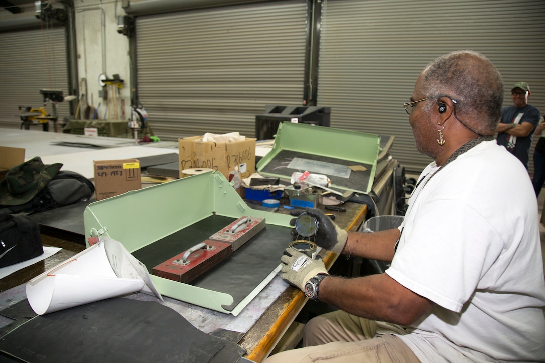 Thomas Allen, mobile equipment metal mechanic, repairs an amphibious assault vehicle box lid in the Canvas Shop at Production Plant Barstow, Marine Depot Maintenance Command, on the Yermo Annex aboard Marine Corps Logistics Base Barstow, Calif., Aug. 16. The Canvas Shop artisans work with myriad materials such as canvas, foam and rubber to repair equipment and components to like-new condition.