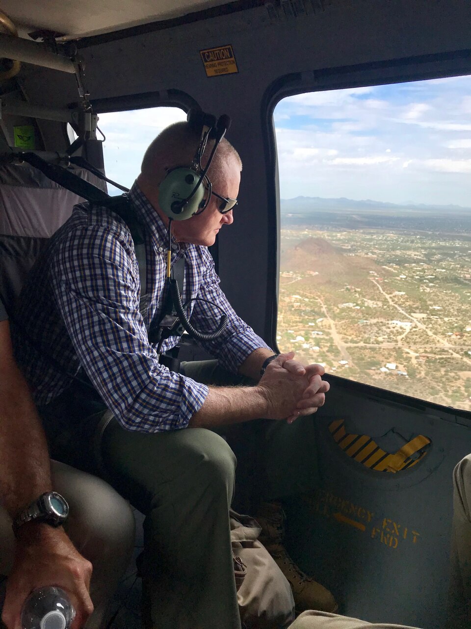 Marine Corps Sgt. Maj. Paul McKenna of North American Aerospace Defense Command and U.S. Northern Command surveils the rural, expansive U.S.-Mexico border area from a Black Hawk helicopter.