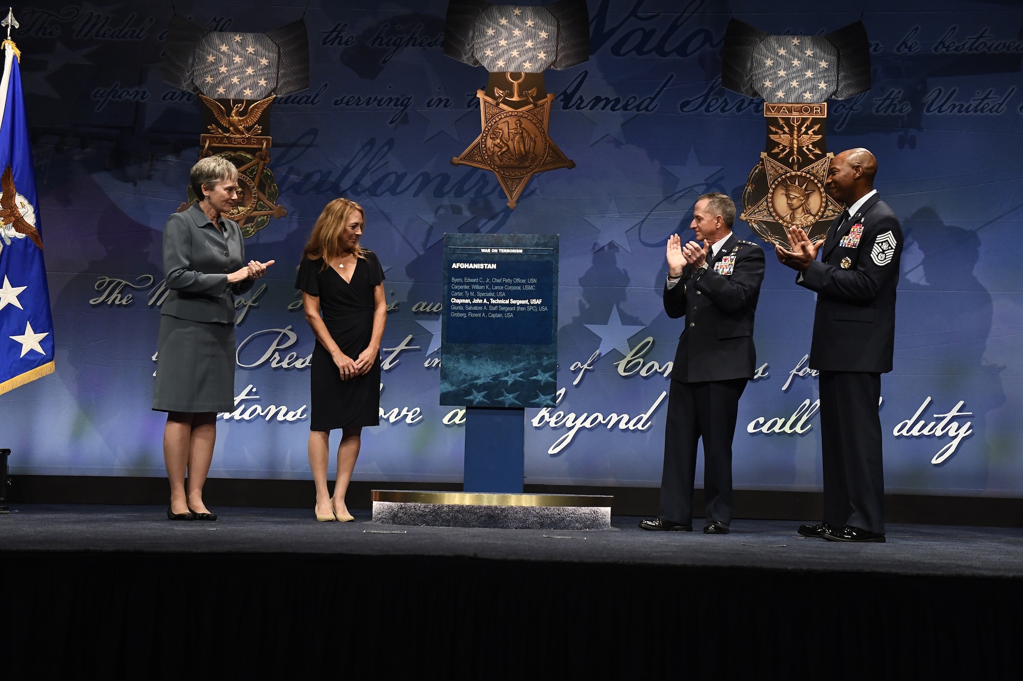 Secretary of the Air Force Heather Wilson, Air Force Chief of Staff Gen. David L. Goldfein and Chief Master Sgt. of the Air Force Kaleth O. Wright unveil Tech. Sgt. John Chapman’s name on the Hall of Heroes plaque as Chapman’s widow, Valerie Nessel, looks on during Chapman’s induction ceremony at the Pentagon, in Arlington, Va., Aug. 23, 2018. Chapman was posthumously awarded the Medal of Honor for actions on Takur Ghar Mountain in Afghanistan March 4, 2002. An elite special operations team was ambushed by the enemy and came under heavy fire from multiple directions. Chapman immediately charged an enemy bunker through thigh-deep snow and killed all enemy occupants. Courageously moving from cover to assault a second machine gun bunker, he was injured by enemy fire. Despite severe wounds, he fought relentlessly, sustaining a violent engagement with multiple enemy personnel before making the ultimate sacrifice. With his last actions he saved the lives of his teammates.  (U.S. Air Force photo by Staff Sgt. Rusty Frank)