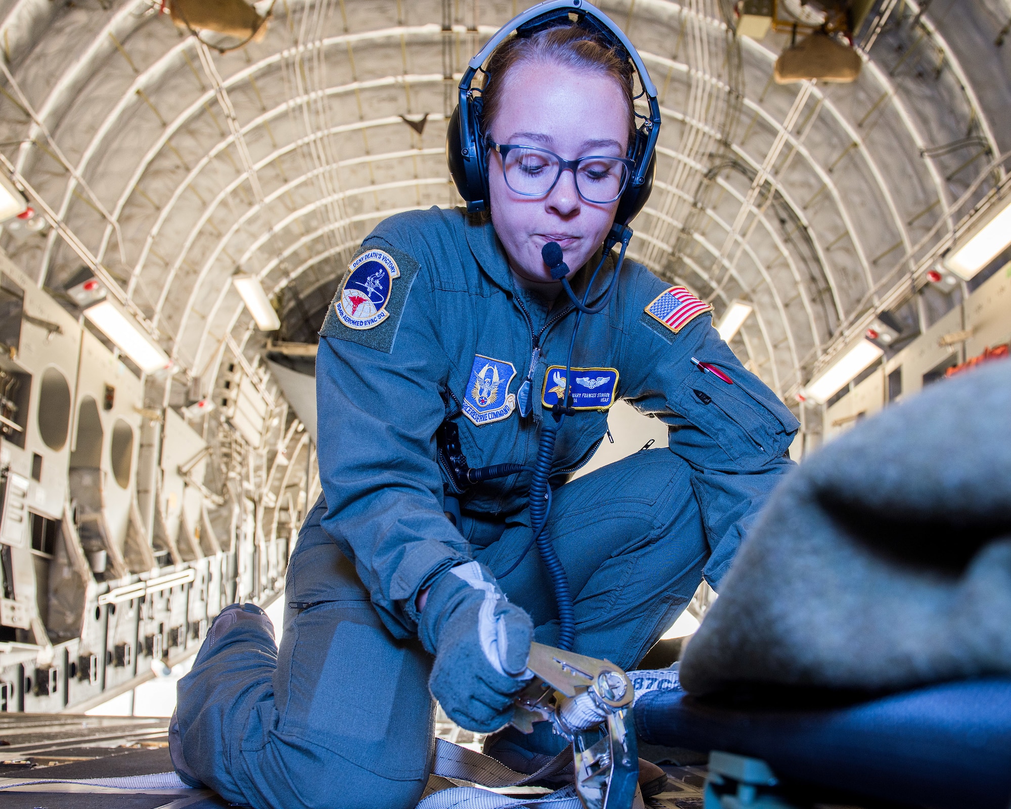 U.S. Air Force Senior Airman Mary Stinson, 934th Aeromedical Evacuation Squadron, secures simulated patients on a C-17 Globemaster III aircraft during Exercise Ultimate Caduceus 2018 at Travis Air Force Base, California, Aug. 22, 2018. Ultimate Caduceus 2018 is an annual patient movement exercise designed to test the ability of U.S. Transportation Command to provide medical evacuation. (U.S. Air Force photo by Louis Briscese)