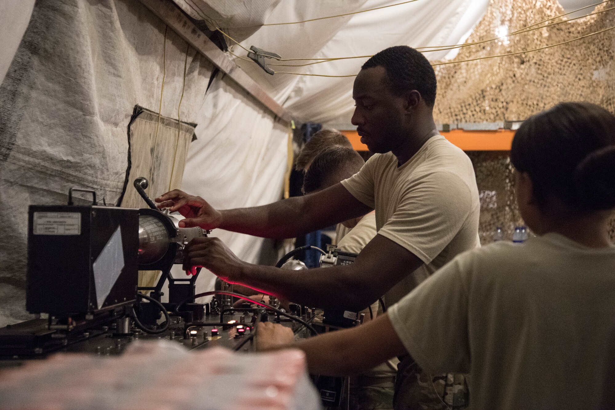 Senior Airman Caleb Feemster, 380th Maintenance Squadron munitions flight, with other munitions flight members and host nation partners, prepares a missile for testing on Al Dhafra Air Base, Aug. 13, 2018. The 380th MXS munitions flight worked with the ADAB host nation partner to test 24 missiles which provided training and fostered partnership between the two nation’s offices. (Photo by Staff Sgt. Erica Rodriguez)