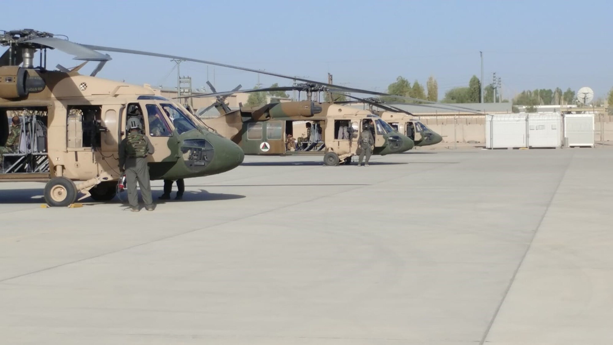 CAMP SHORAB, Afghanistan (July 10, 2018) --  Afghan Air Force (AAF) UH-60 crews prepare the aircraft before going out on the first operational mission July 10, 2018, while deployed to Camp Shorab, Afghanistan. The mission provided transportation to 22 passengers while providing area familiarization for the pilots in Helmand province. (U.S. Marine Corps photo by Sgt. Luke Hoogendam)
