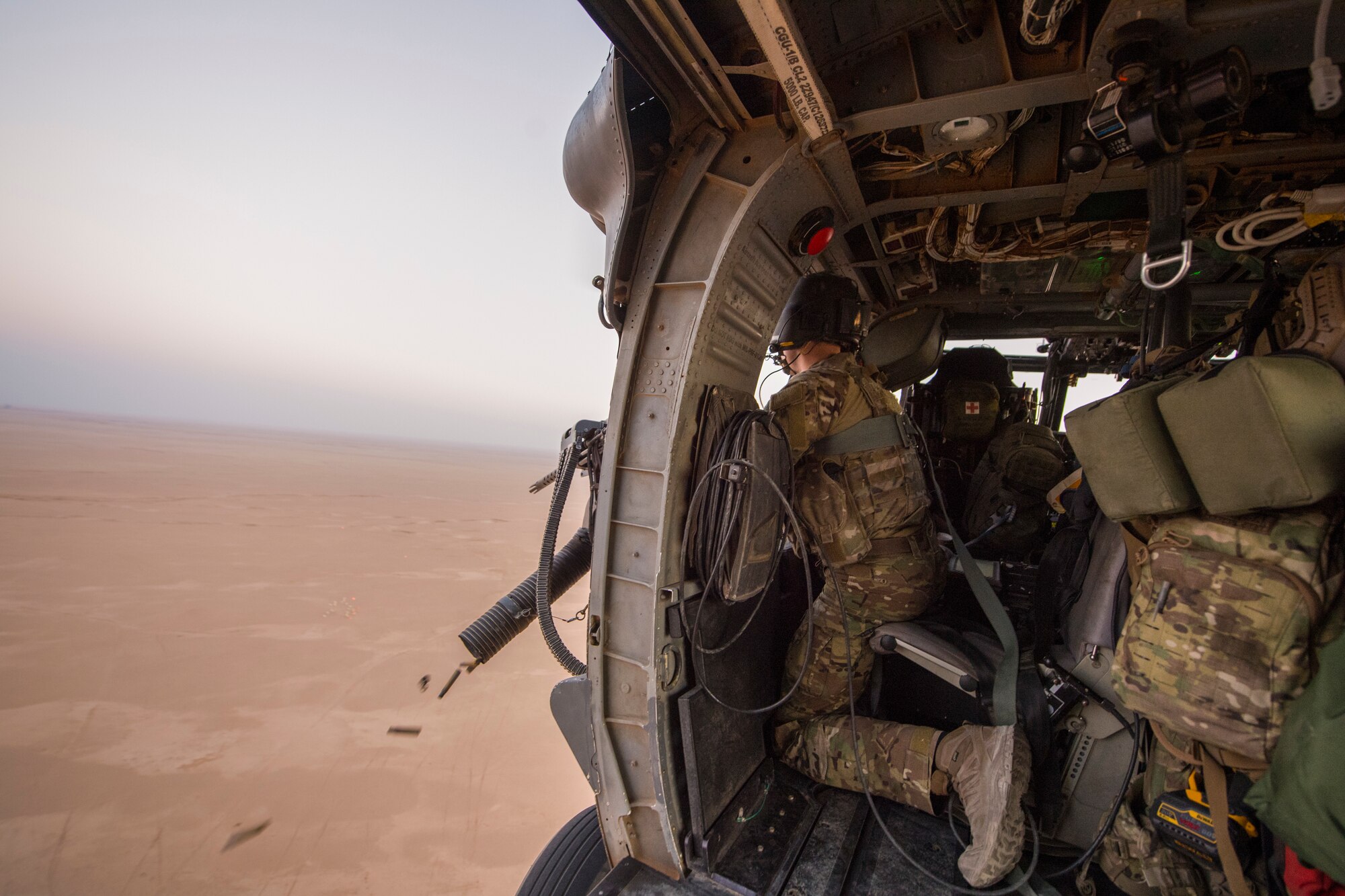 A U.S. Air Force special mission aviator assigned to the 46th Expeditionary Rescue Squadron (ERQS) test fires a .50 caliber GAU-18 during a training mission over Iraq, July 18, 2018. The 46th ERQS provides combat search and rescue capabilities across the region in support of Operation Inherent Resolve. In conjunction with partner forces, Combined Joint Task Force - Operation Inherent Resolve defeats ISIS in designated areas of Iraq and Syria and sets conditions for follow-on operations to increase regional stability.(U.S. Air Force photo by Staff Sgt. Keith James)
